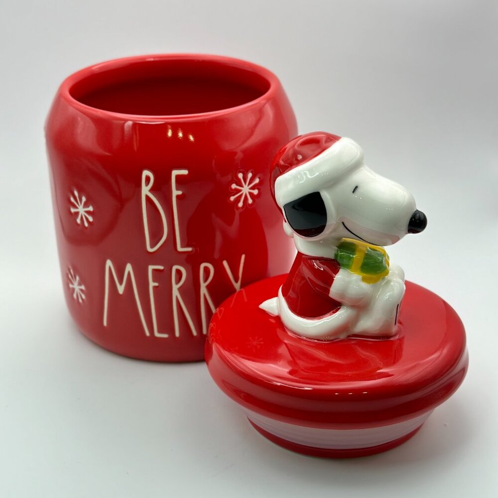 Snoopy figurine holding a present treat jar by Rae Dunn | Be Merry canister